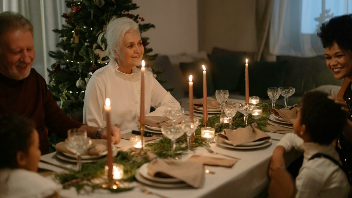 Why You Should Consider Providing for Grandchildren in Your Will Festive dinner setting with grandparents and grandchildren.